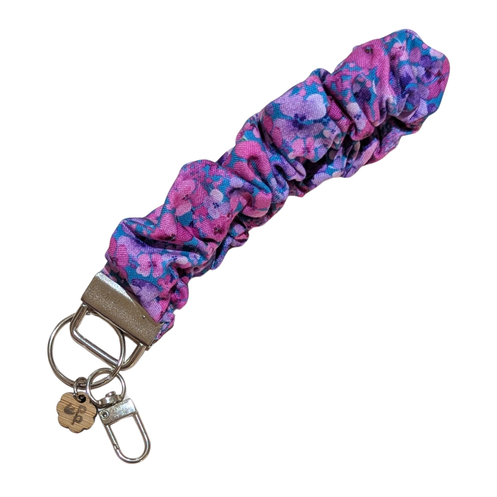 Handmade scrunchie wristlet with purple floral print — soft, stretchy, and ideal for keeping keys handy.
