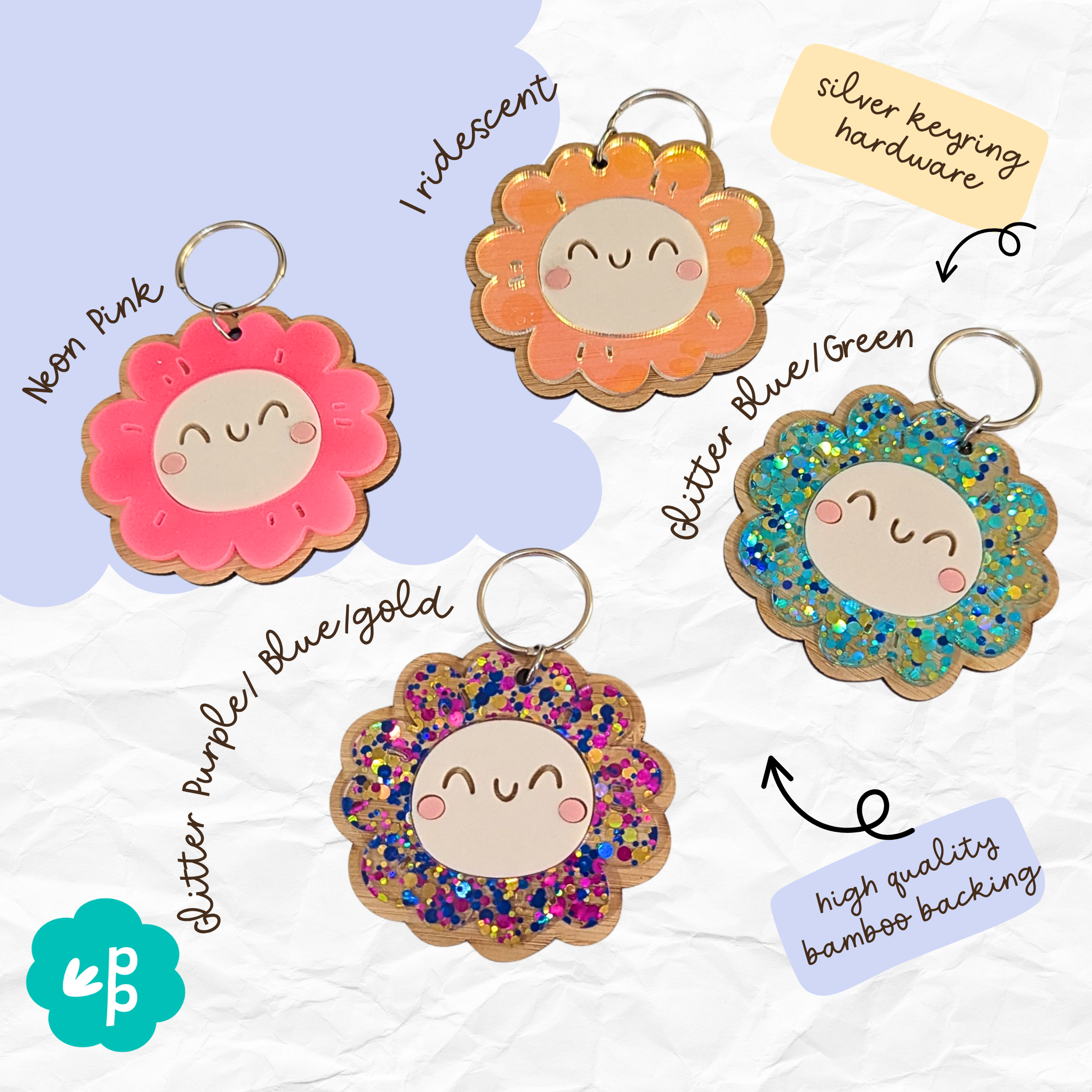 Bright glitter and iridescent smiley flower keyrings in blue, orange, pink, and multicolor with bamboo backing and silver hardware by Priority Play.