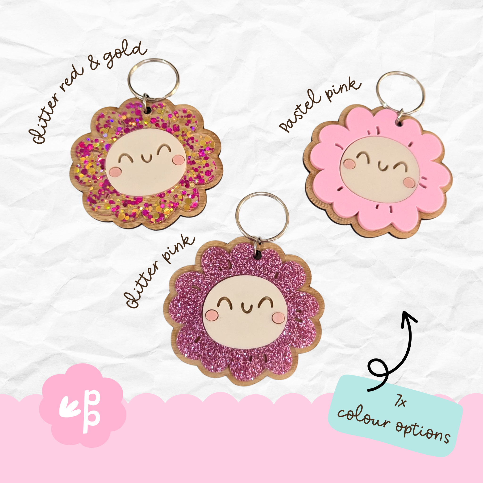 Pink smiley keyrings with glitter and pastel designs showing 7 color options, handcrafted bamboo flower keychains from Priority Play.