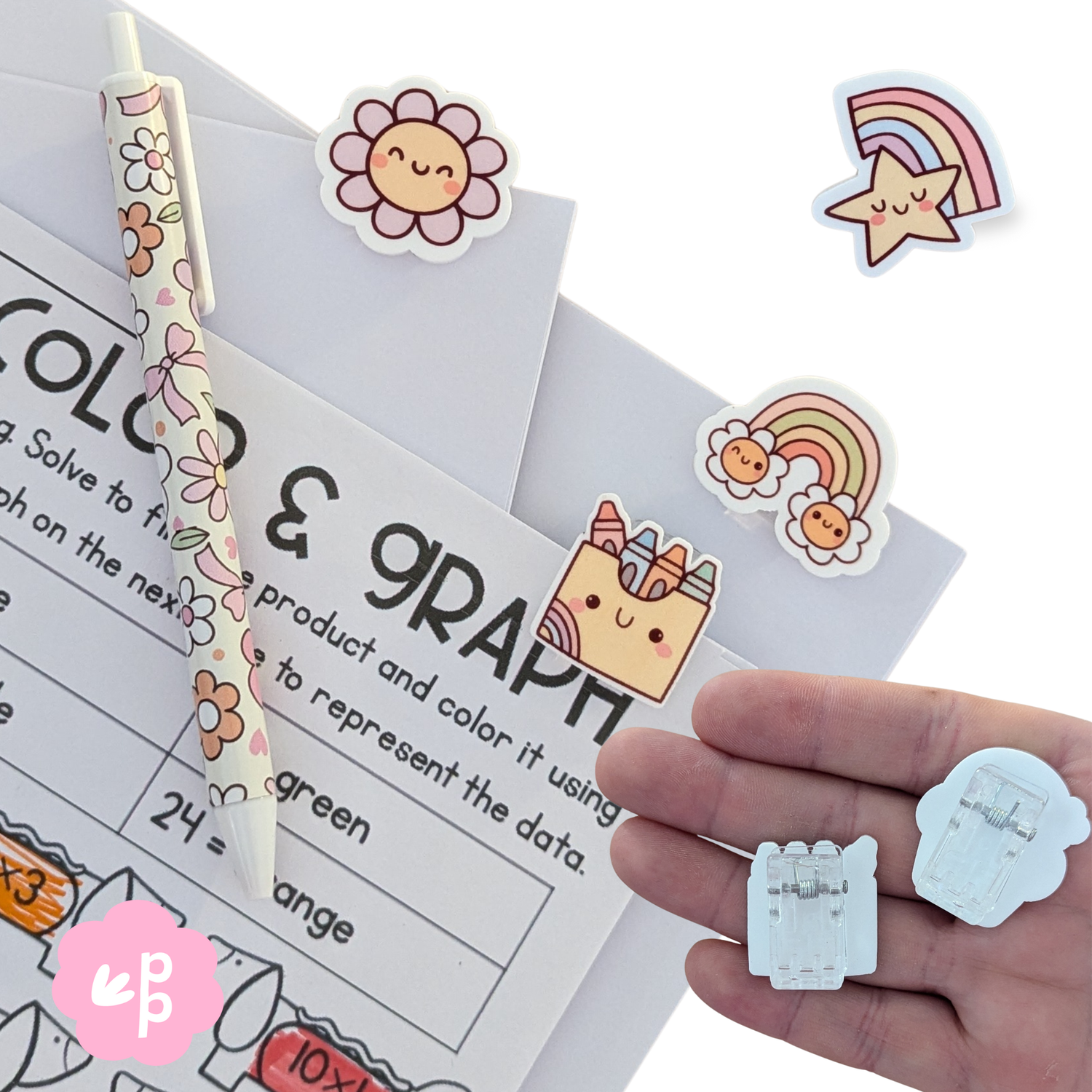 Cute acrylic stationery clips featuring smiling flowers, rainbows, and stars holding student worksheets – fun classroom accessories from Priority Play.