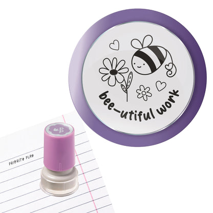 A smiling bee with flowers and hearts and the text “bee-utiful work” on a circular teacher stamp.
