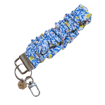 Handmade blue and yellow floral scrunchie wristlet keychain — pretty and functional accessory for holding keys.