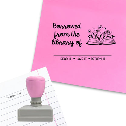 A rectangular stamp reading “Borrowed from the library of” with a floral illustrated book icon, customisable name space, and “Read it • Love it • Return it”.