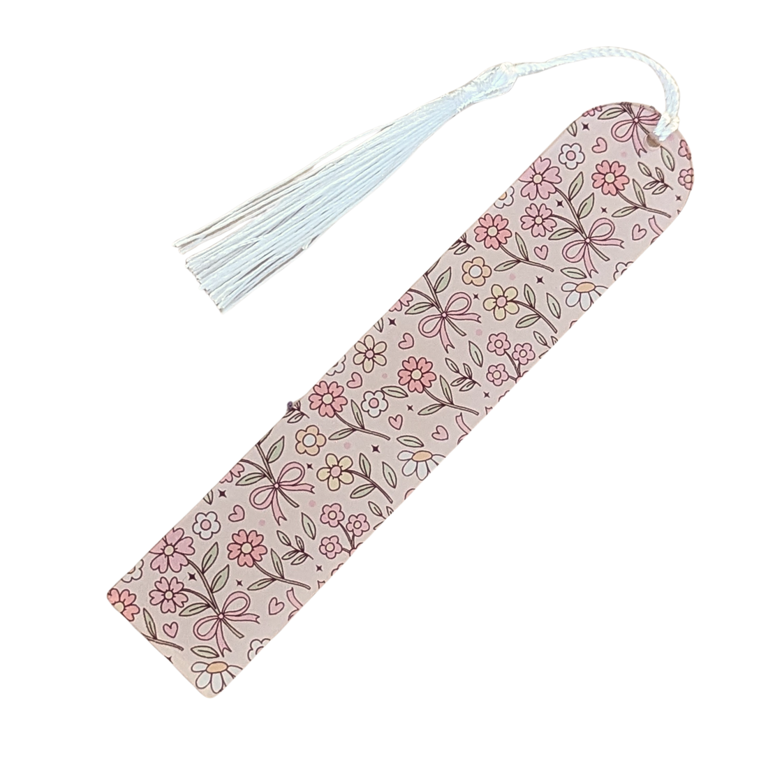 Handmade acrylic bookmark with cream floral and bow pattern and white tassel.
