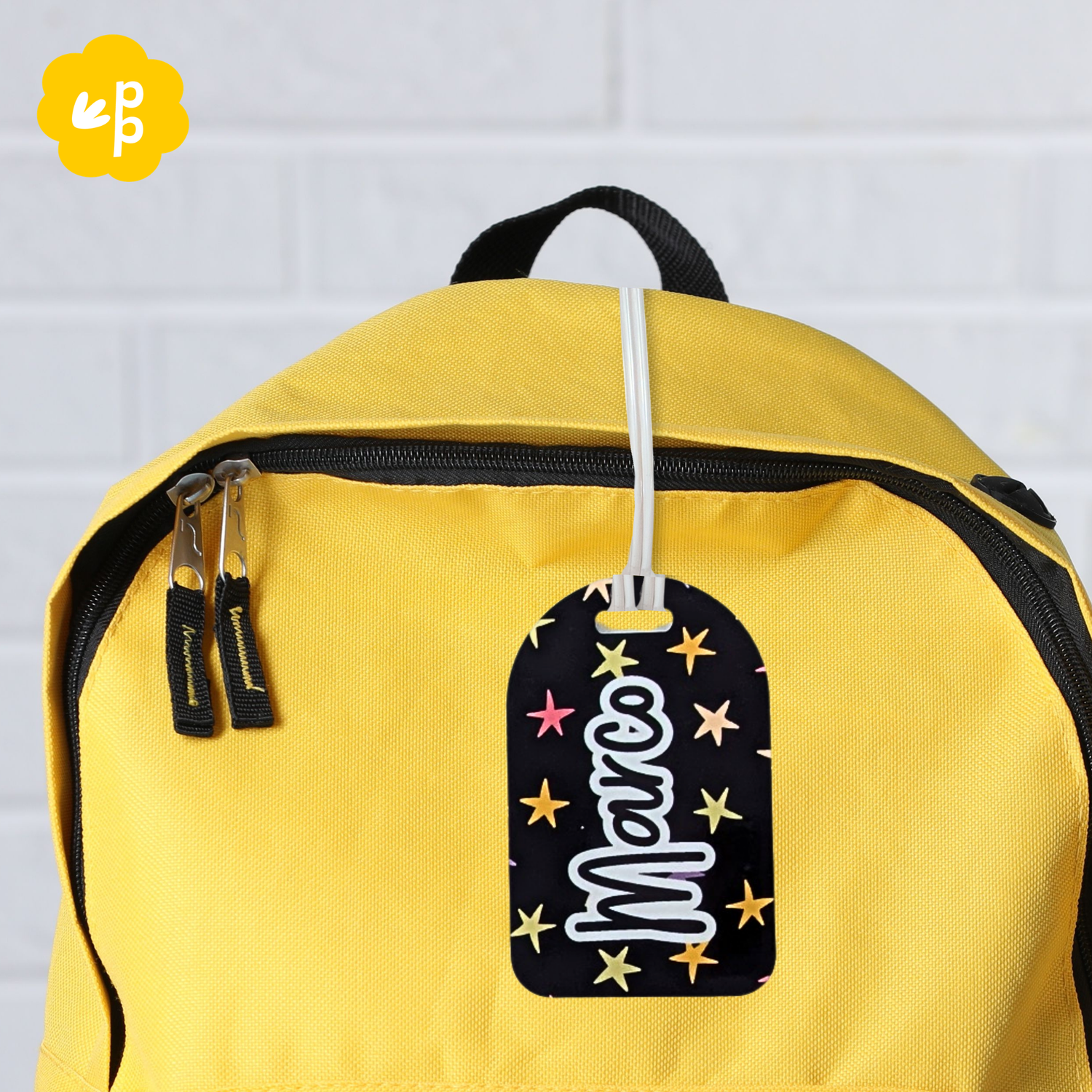 Custom name bag tag with star pattern attached to yellow backpack, personalised kids luggage tag by Priority Play