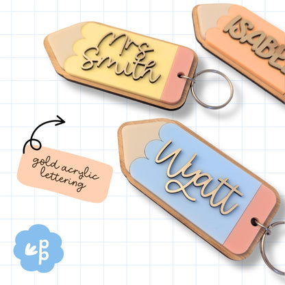 Close up of personalised pencil keyring with raised gold acrylic name lettering and bamboo backing detail