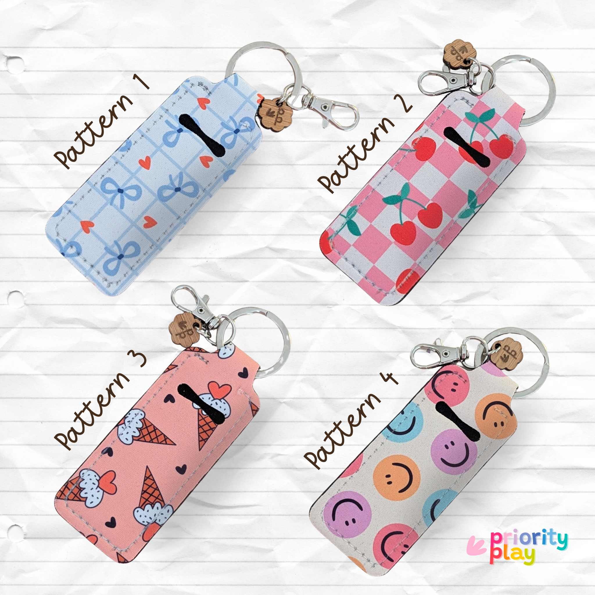 Cute lip balm holder keychains in four fun patterns — bows, cherries, ice cream cones and smiley faces — perfect for lip gloss or chapstick, by Priority Play.
