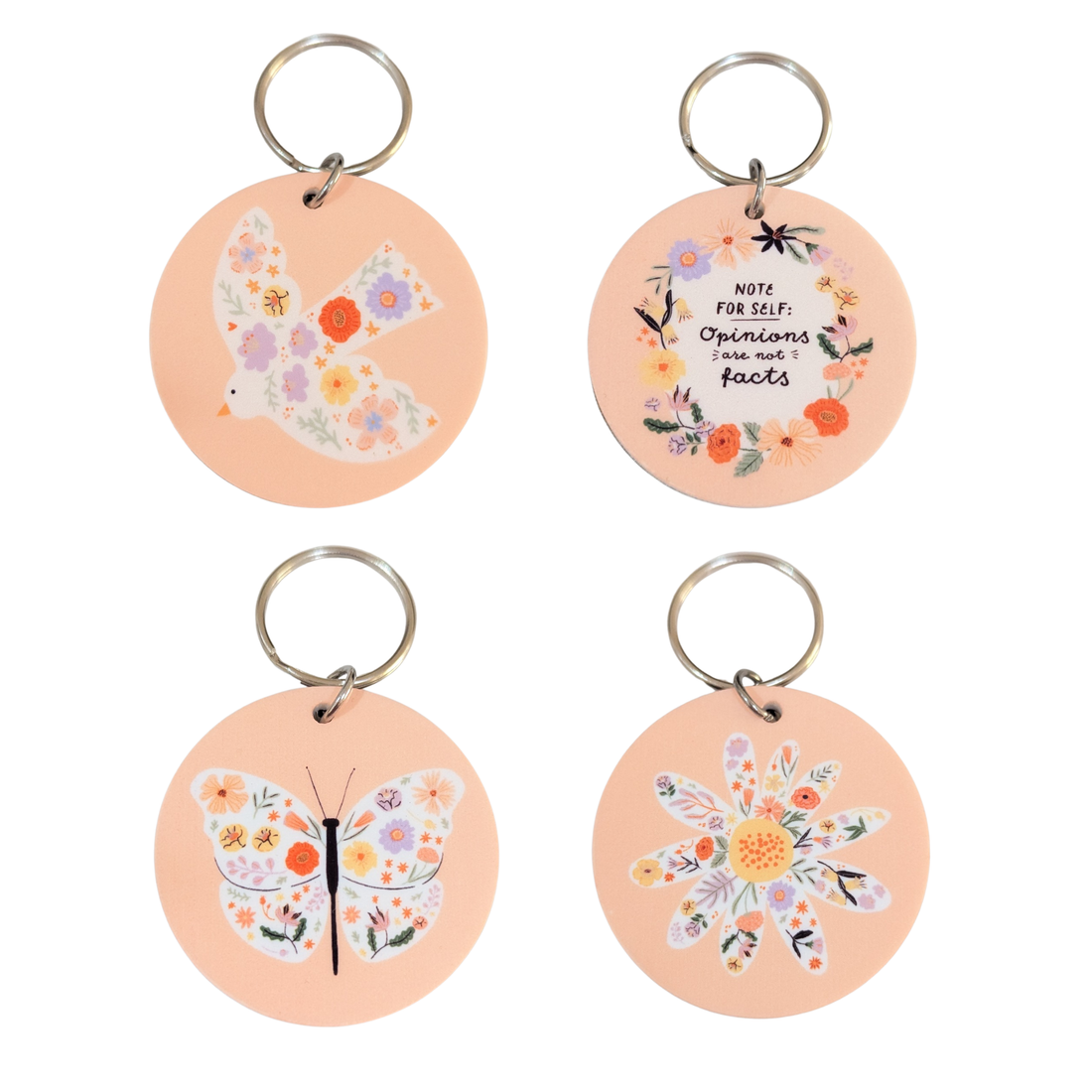 Set of floral keyrings including a bird, butterfly, daisy flower, and motivational quote design on peach background.