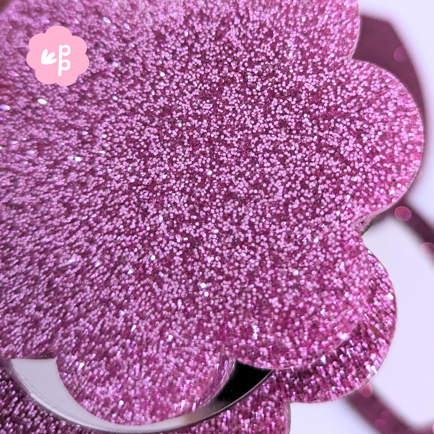 Close up of pink glitter acrylic flower pocket mirror showing sparkly textured finish and compact design by Priority Play