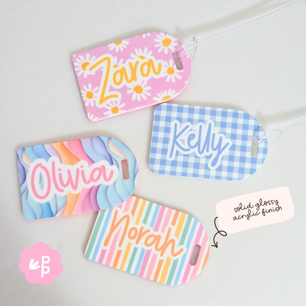Close up of personalised acrylic bag tags showing glossy finish and vibrant pastel colours by Priority Play