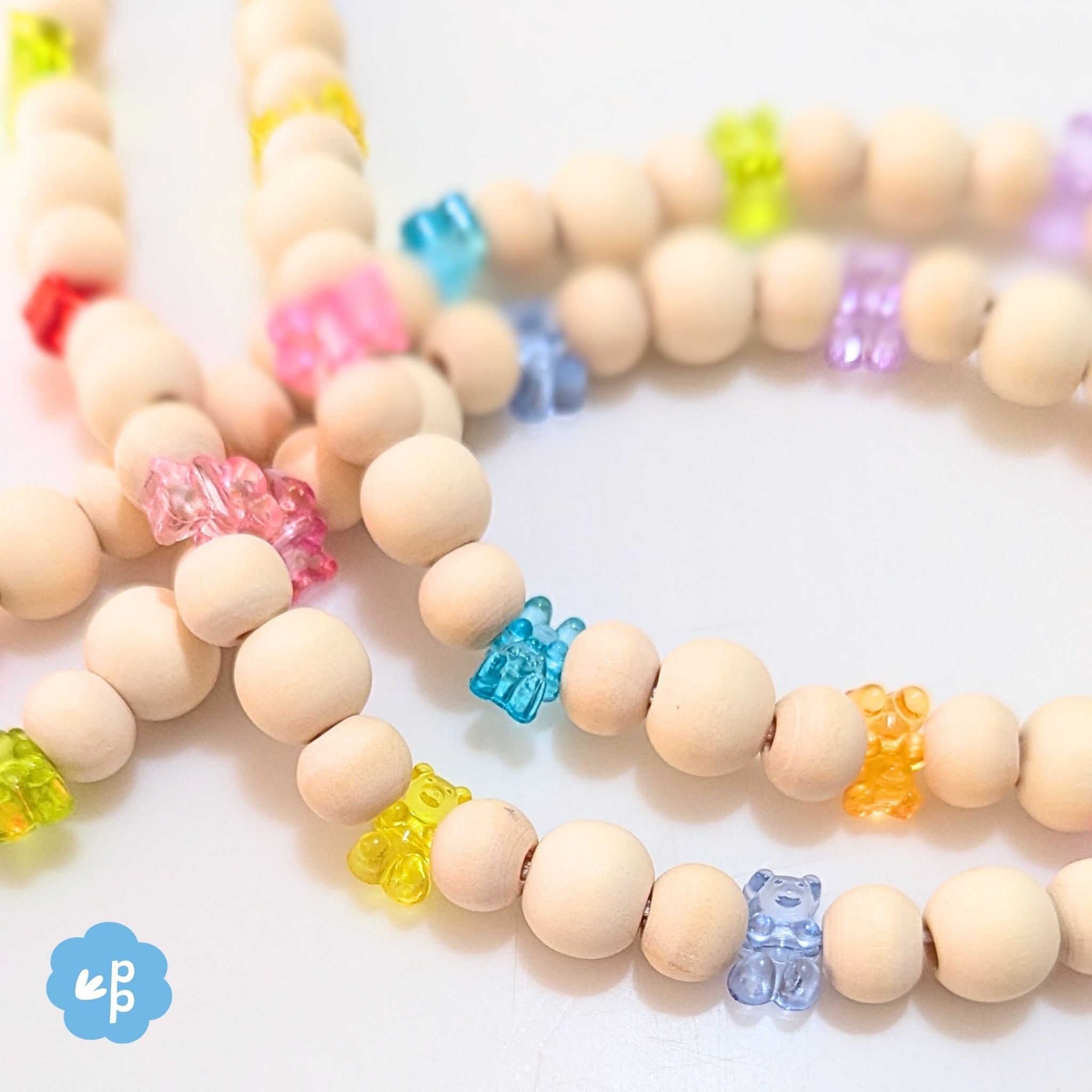 Close up of handmade beaded lanyard with wood beads and bright gummy bear beads in rainbow colours