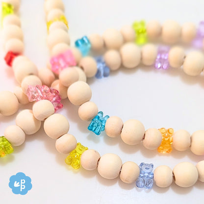 Close up of handmade beaded lanyard with wood beads and bright gummy bear beads in rainbow colours
