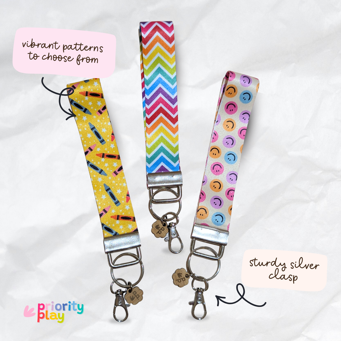 Handmade fabric wristlet keychains in vibrant patterns with silver clasp, perfect for teachers and holding keys.