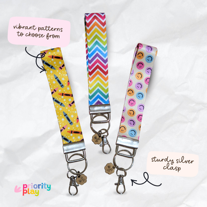 Handmade fabric wristlet keychains in vibrant patterns with silver clasp, perfect for teachers and holding keys.