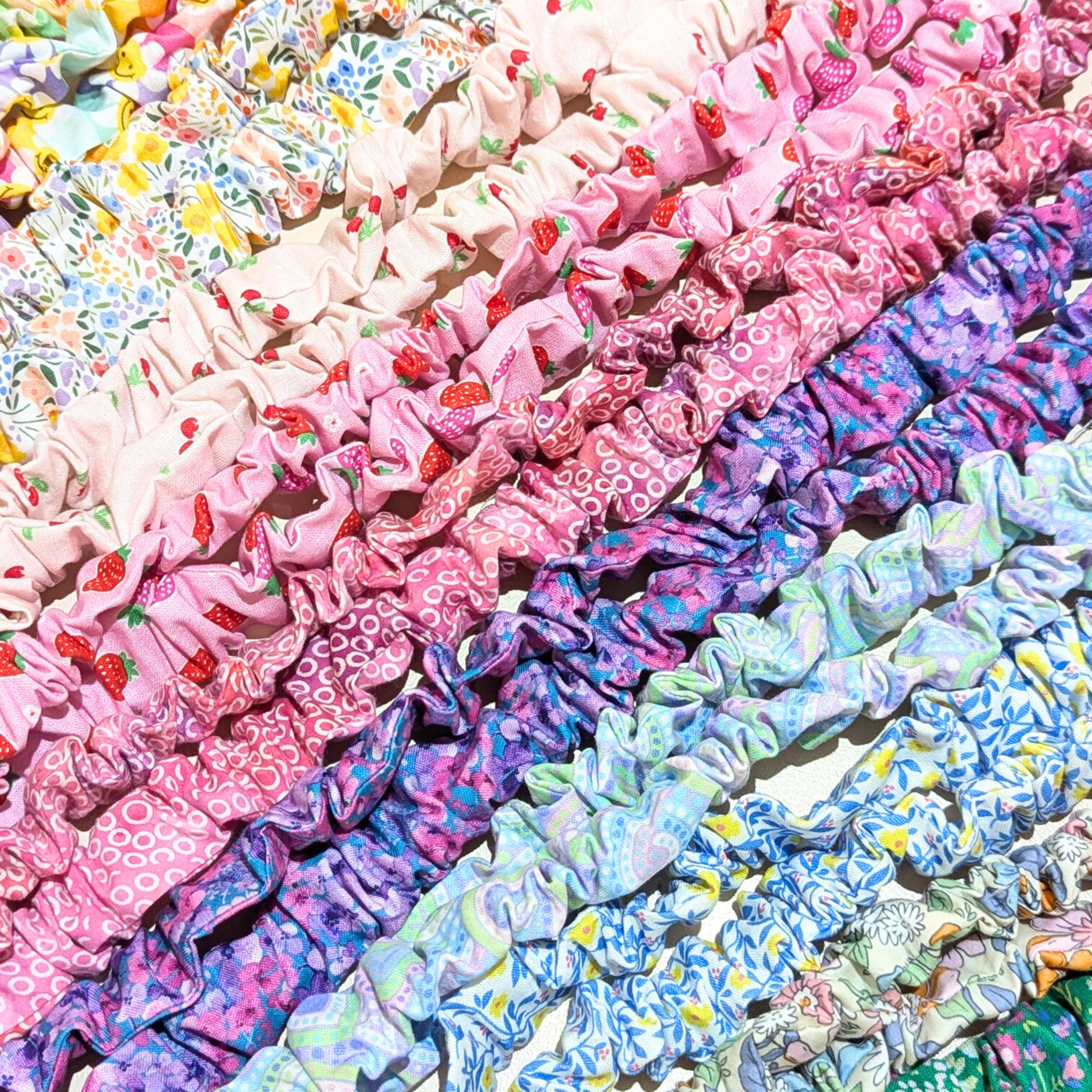 Collection of handmade fabric key fob wristlets and lanyards for teachers in colorful floral and patterned fabrics, featuring pink, purple, blue, and green designs.