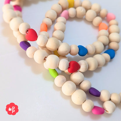 Close up of wooden bead lanyard with vibrant heart beads in multiple colours
