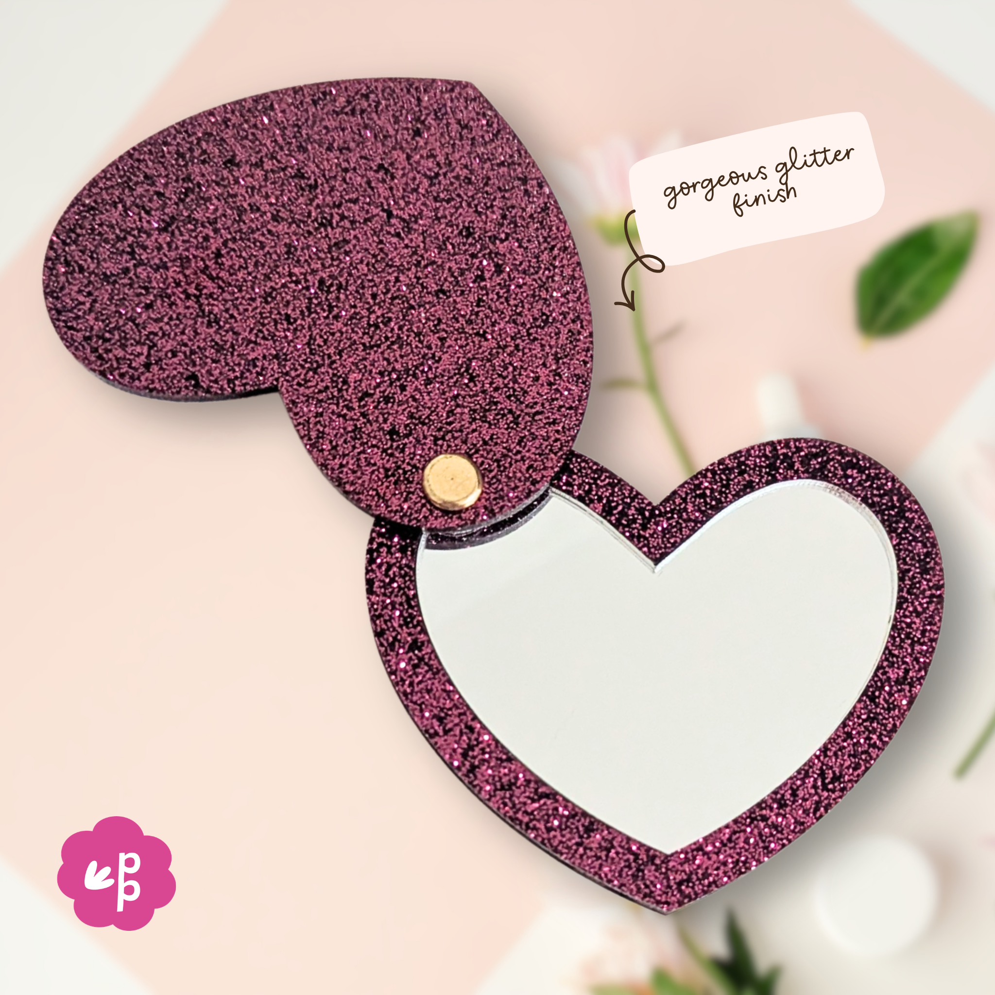 Close up of heart glitter acrylic pocket mirror showing gold hardware hinge and bamboo backing detail by Priority Play