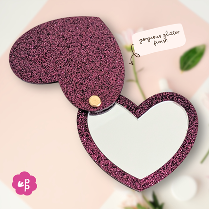 Close up of heart glitter acrylic pocket mirror showing gold hardware hinge and bamboo backing detail by Priority Play