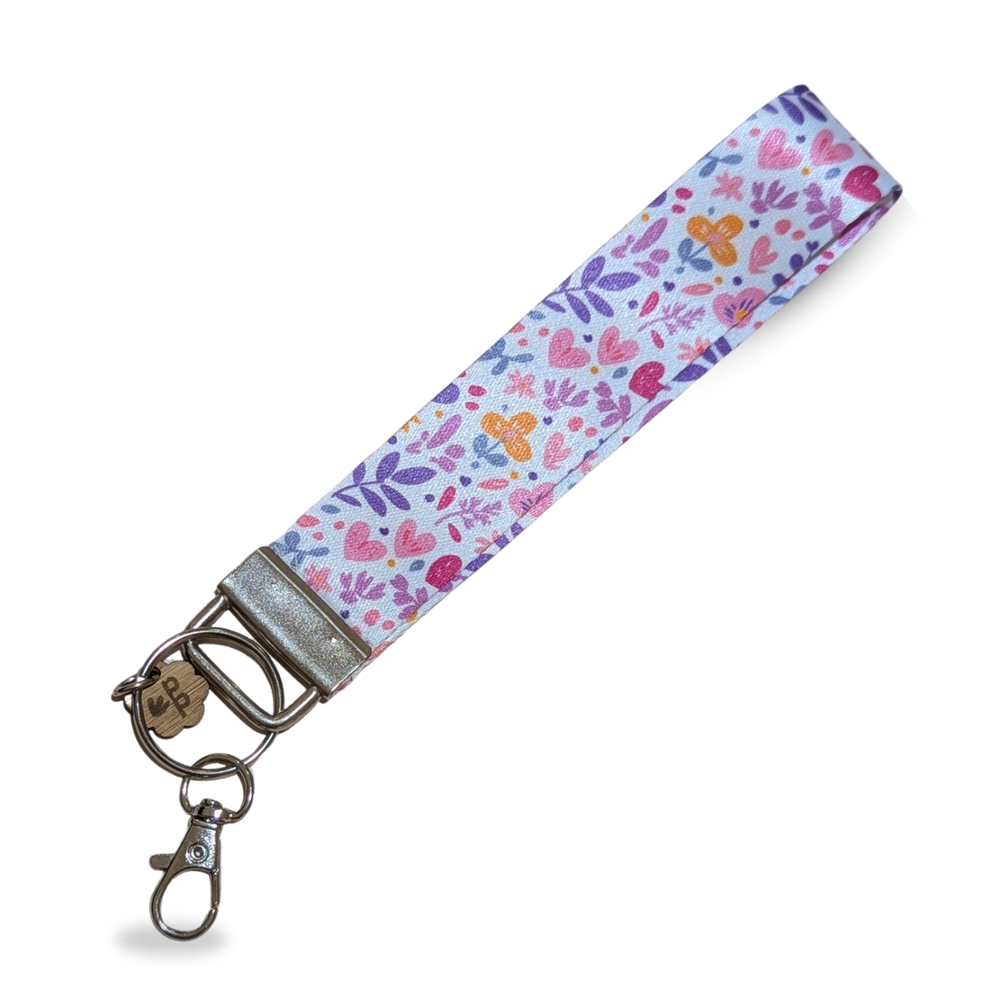 Handmade fabric wristlet keychain with pink heart and leaf print, a sweet gift for teachers.
