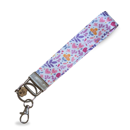 Handmade fabric wristlet keychain with pink heart and leaf print, a sweet gift for teachers.