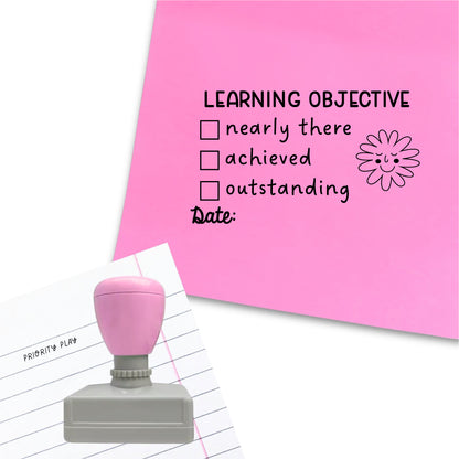 Stamp titled “Learning Objective” with check boxes for nearly there, achieved, and outstanding, plus date line and flower character illustration.