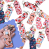 Collection of colorful lip gloss holder keychains with ice cream, cherry, strawberry and floral prints — fun and practical accessory by Priority Play.