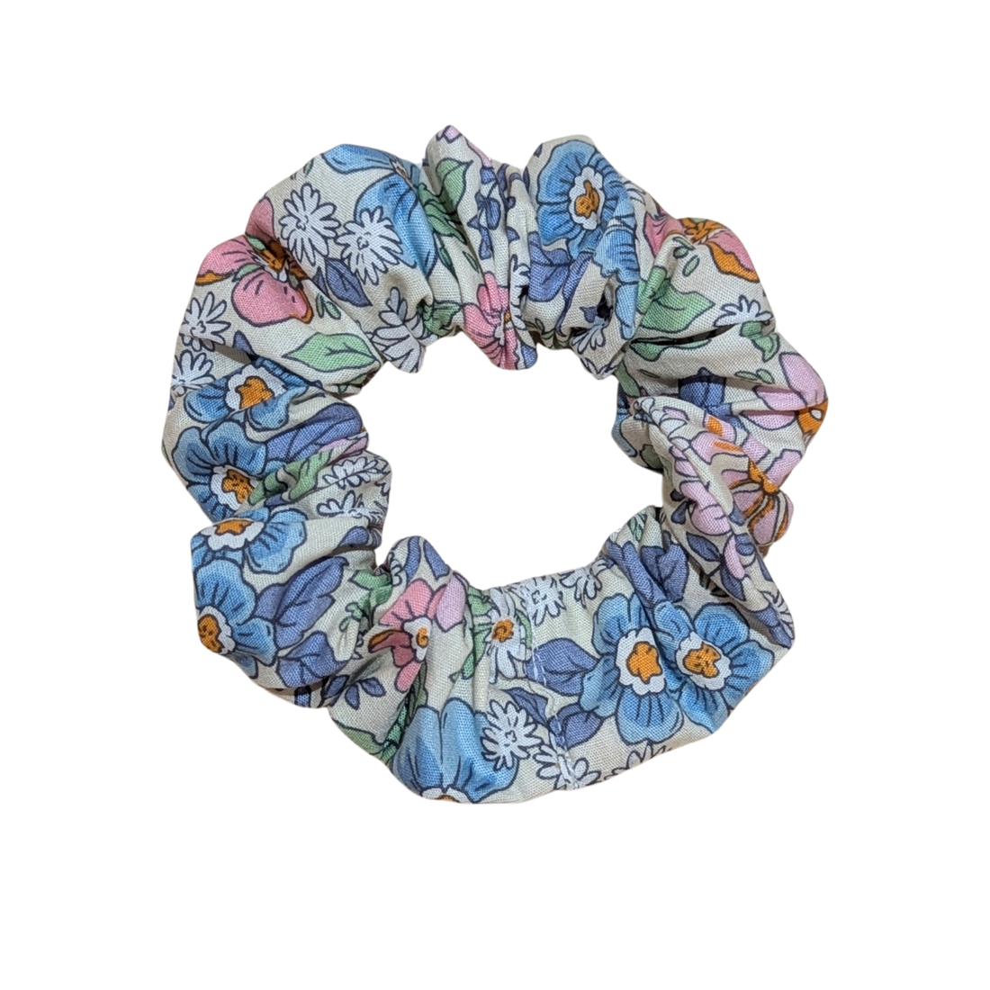 Handmade scrunchie with soft pastel floral pattern in blue and pink tones