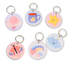 Pastel key tag collection by Priority Play featuring cute illustrated designs including a snail, coffee cup, star, rainbow, dragonfly, and cloud with engraved bamboo backing