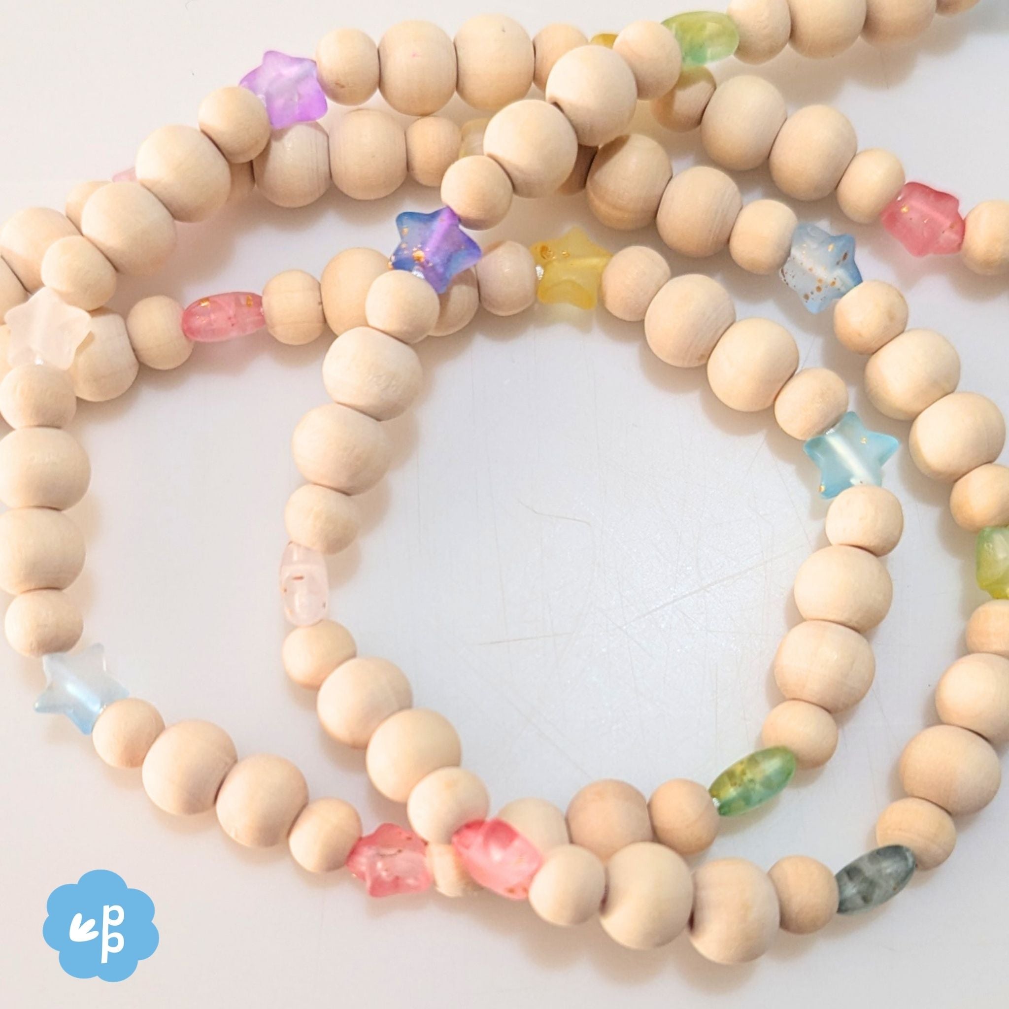 Close up of beaded lanyard with wooden beads and pastel star feature beads