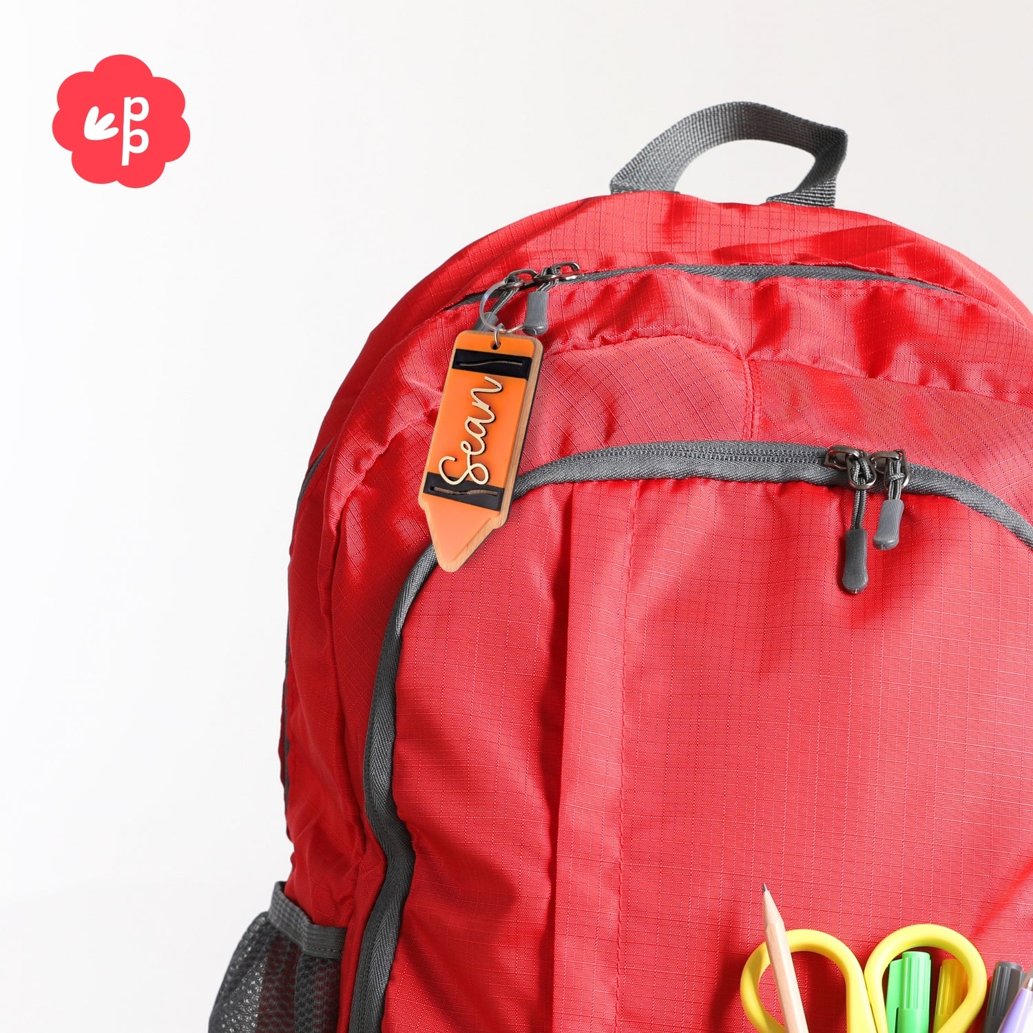 Personalised pencil bag tag keyring attached to school backpack, custom name label for kids, students and teachers