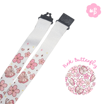 Floral-patterned teacher lanyard with pink butterflies on a white background, featuring the brand &