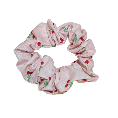 Handmade pink scrunchie with red cherry print and green leaves