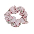 Handmade pink scrunchie with red cherry print and green leaves