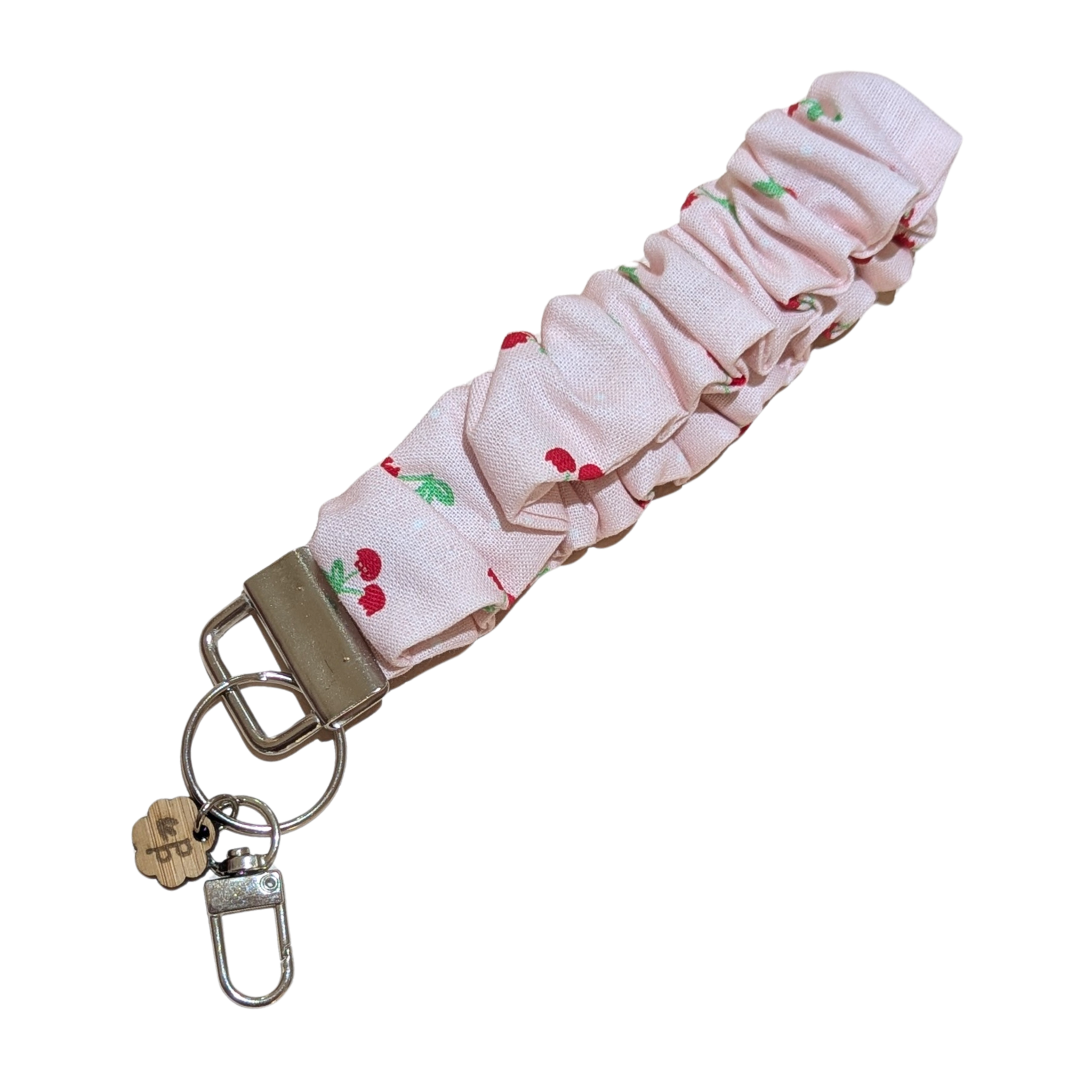 Handmade pink cherry scrunchie wristlet keychain by Priority Play, featuring soft gathered fabric and a sturdy silver clasp — perfect for holding keys or gifts for teachers.