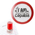 Priority Play “I Am Capable” teacher stamp with red border shown beside notebook.