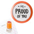 Priority Play “I’m Proud of You” teacher stamp with orange border on lined school paper.
