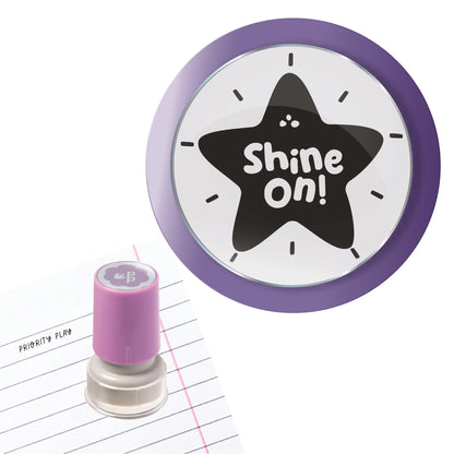 Purple teacher stamp with a star design and the positive message “Shine On!” in playful handwritten text.
