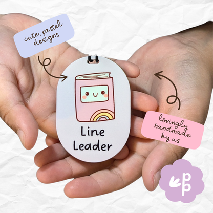 Children holding Reporter and Recorder classroom role tags during group activities, encouraging collaboration, motivation, and teamwork by Priority Play.
