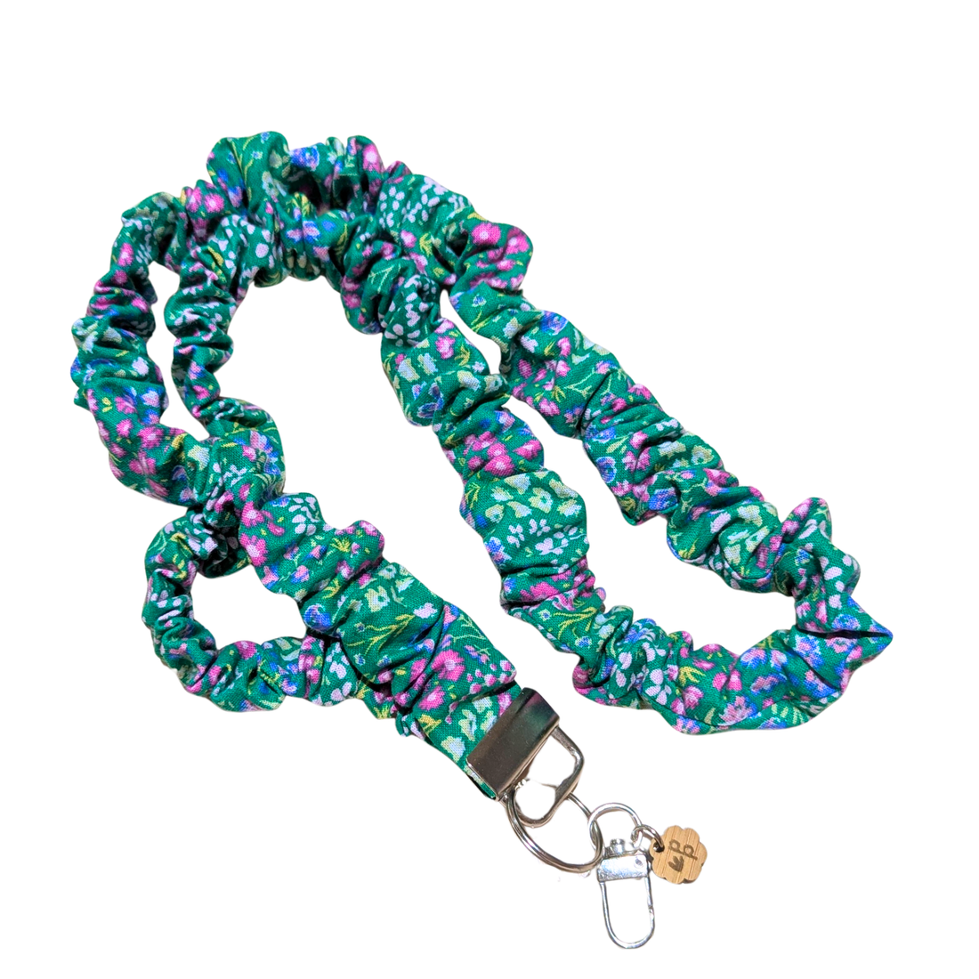 Floral patterned teacher scrunchie lanyard with a metal clip on a white background 