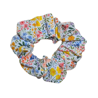 Handmade white scrunchie with small colorful floral meadow design