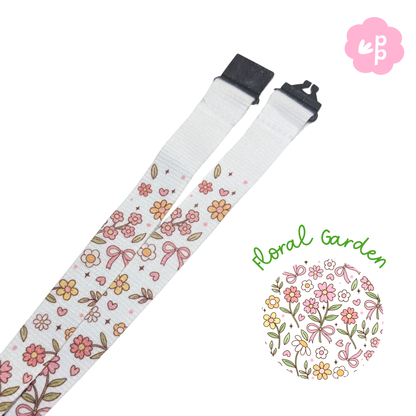 Floral patterned teacher lanyard with a black breakaway clasp on a white background