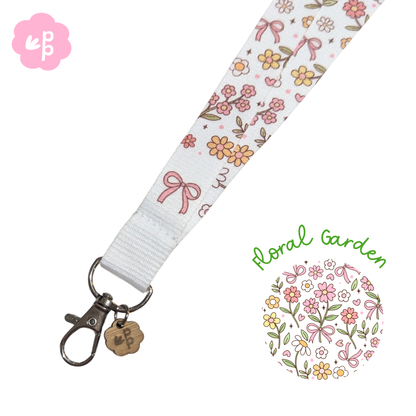 Floral garden-themed lanyard with flowers and bows on a white background with silver clasp