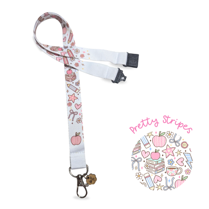 White teacher lanyard with colorful stationery designs on a white background