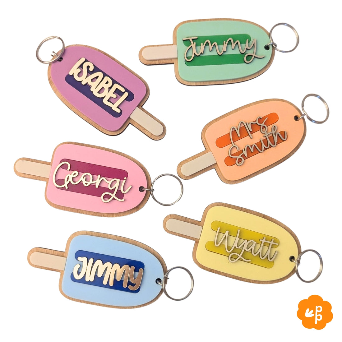 Personalised teacher name keychains in popsicle shape with pastel acrylic colours and bamboo backing, featuring custom names in gold lettering